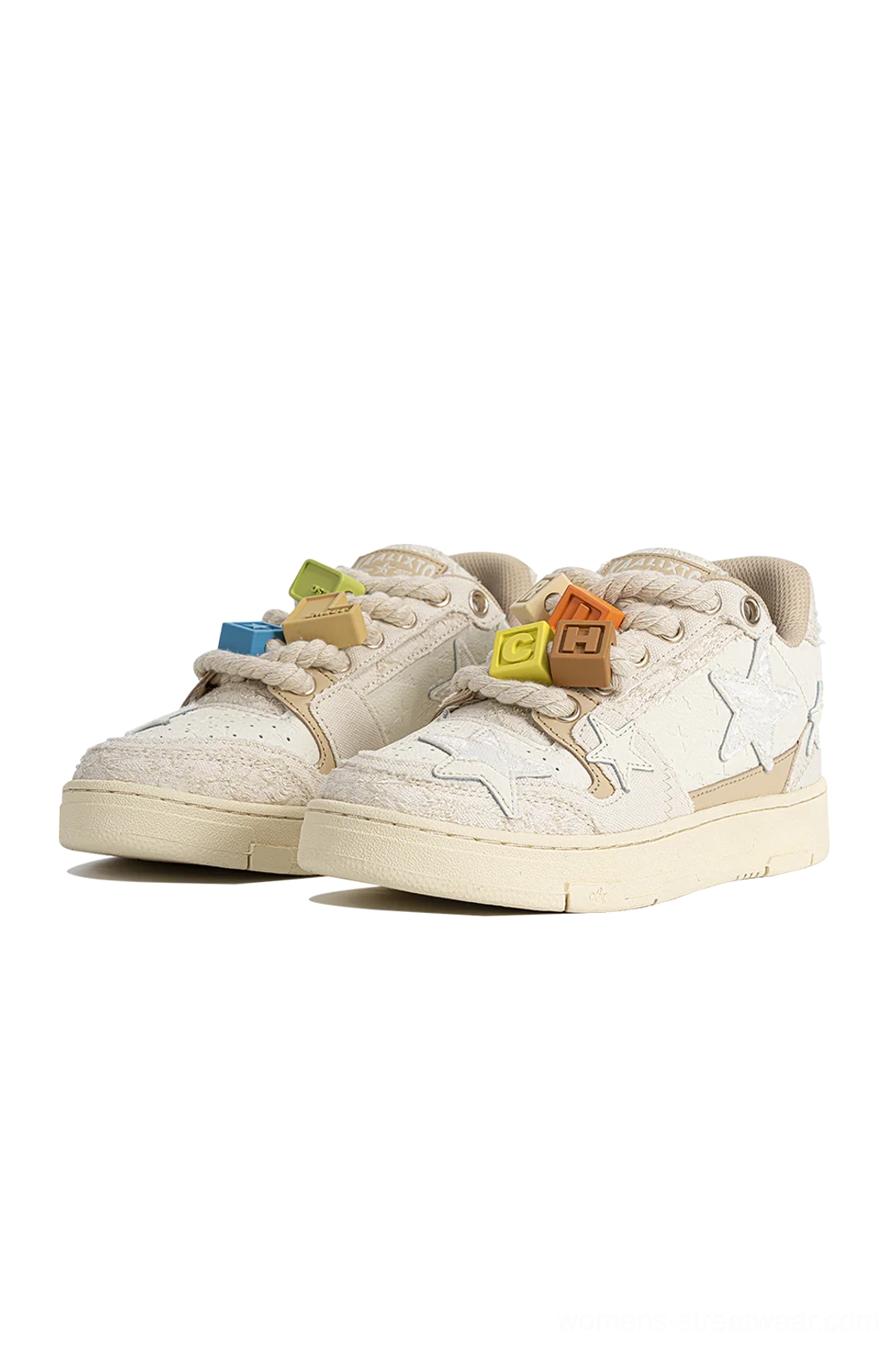 Beige low-top sneakers with matching lace charms, neat star applique details, dimensional lace texture, and thick rubber outsole on a light background