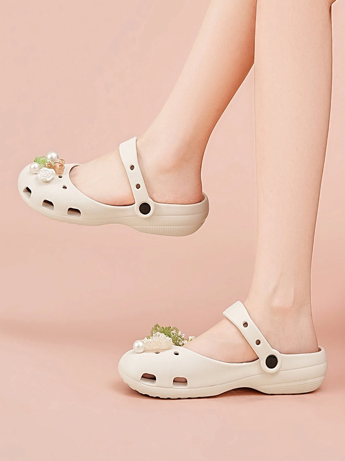 Off-white beige decorative Mary Jane slide sandals worn on feet against a light pink studio background with breathable hollow upper