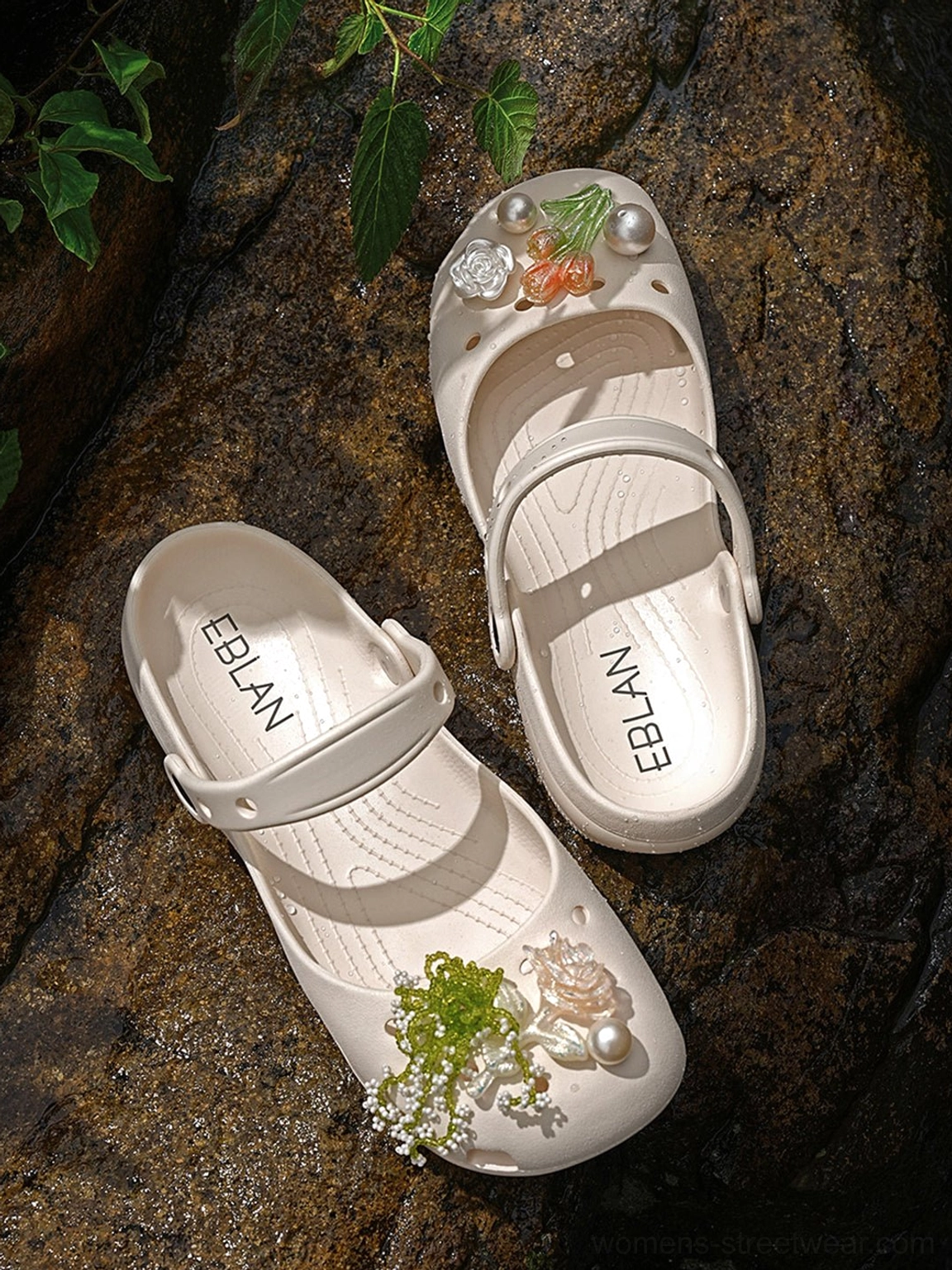 Pair of beige Mary Jane slide sandals in top-down view with floral pearl decorations adjustable buckle straps and textured breathable upper