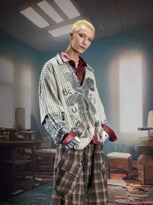 Beige oversized patchwork knit pullover with vintage cartoon graffiti graphic contrast shirt collar and plaid cuffs styled with wide leg pants