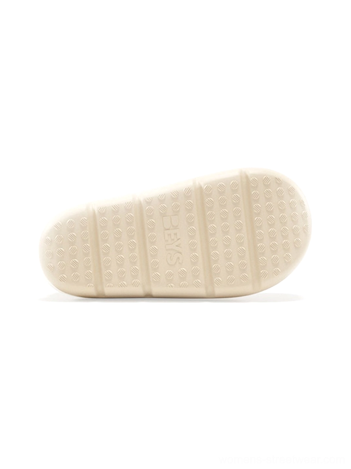 Textured outsole of beige platform winter boots showing dotted traction pattern and elevated sole construction