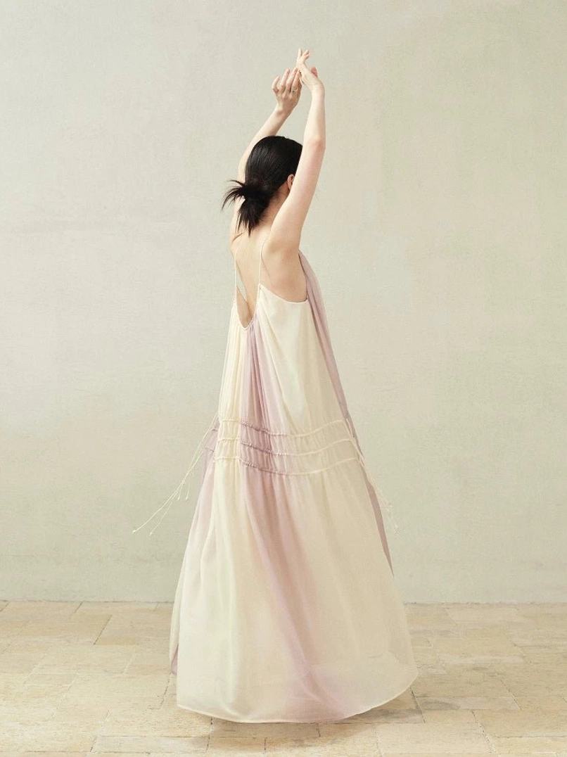 Back view of beige purple gradient spaghetti strap maxi slip dress with low open back