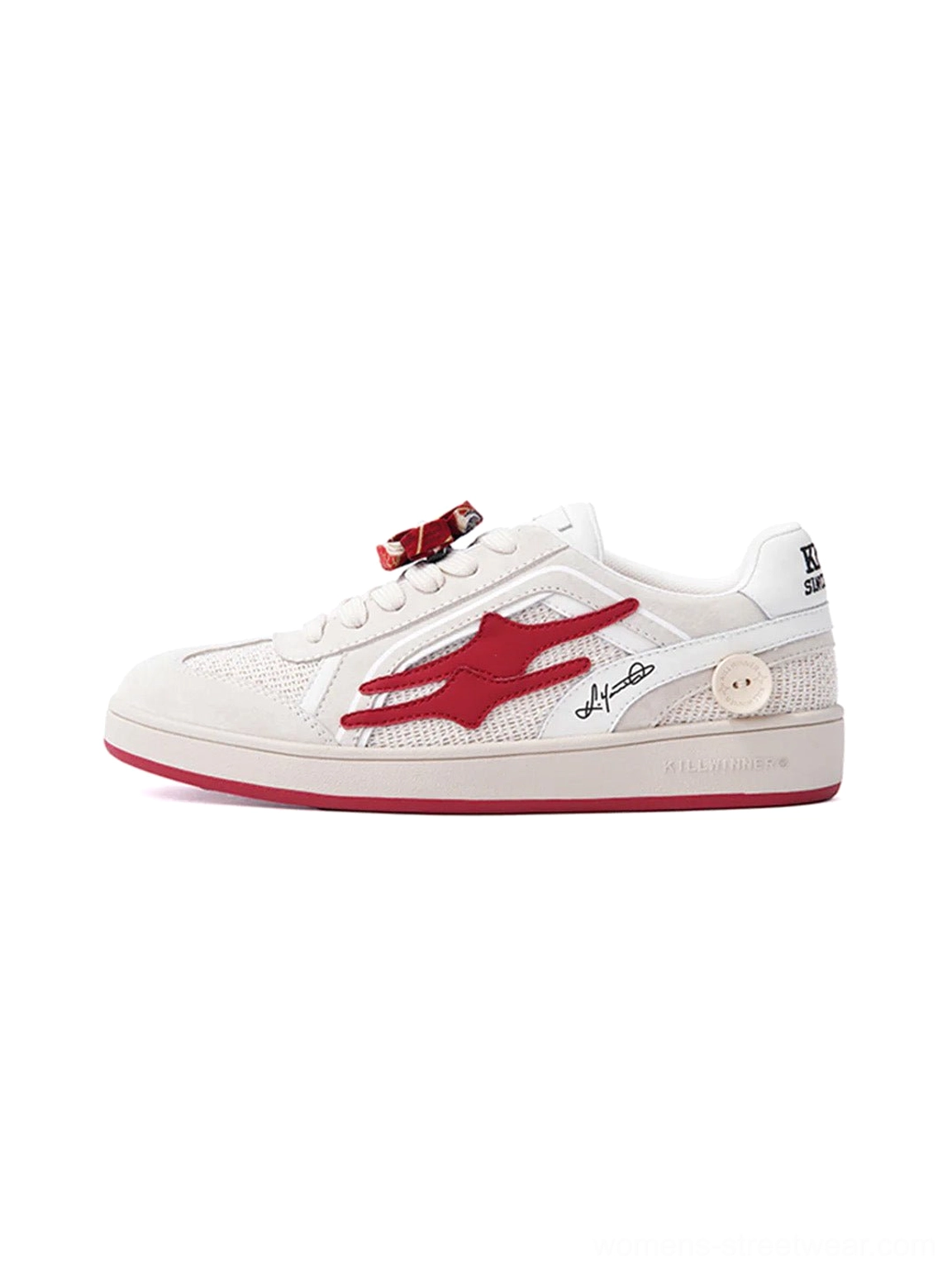 Beige and red retro training sneaker shown in a side-front product view with layered suede panels, red flame side graphic, flower lace ornament, and red rubber outsole