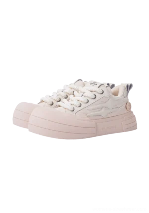 Beige smile panel platform sneaker in a side front view with layered upper panels, chunky rounded rubber sole, lace-up closure, and rear pull tab