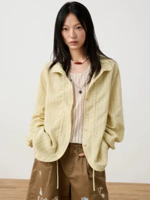 Beige textured striped Mandarin collar button blouse styled with a camisole, embroidered brown cargo shorts, and relaxed Korean streetwear details