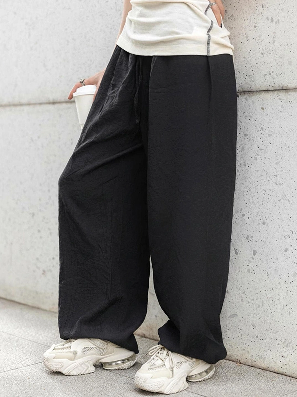 Beige Vortex Mesh Air Cushion Platform Sneakers styled with wide leg black pants in an urban streetwear outfit