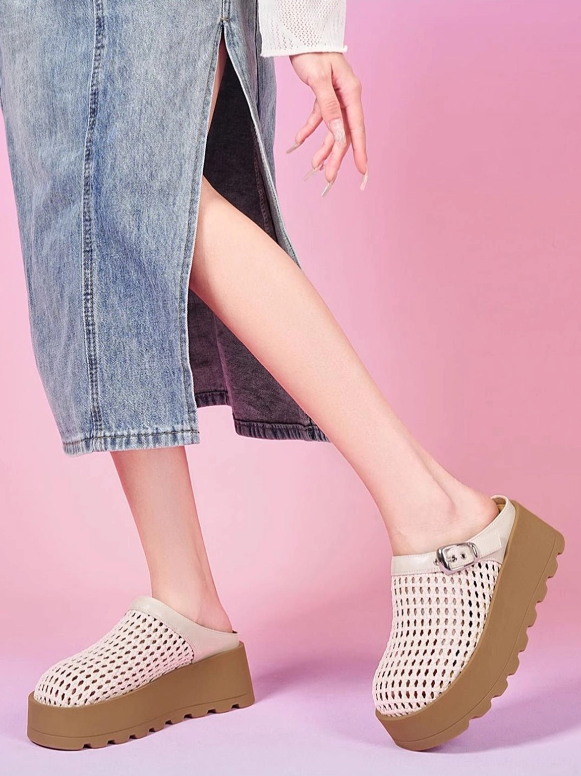 Model wearing beige woven platform mules with brown chunky sole and silver buckle styled with a casual denim midi skirt