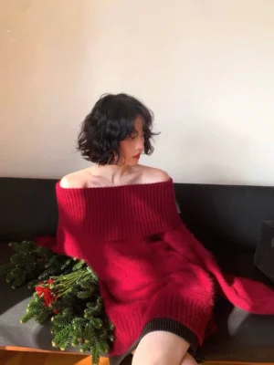 Berry red off-shoulder fuzzy knit sweater with wide ribbed neckline and relaxed oversized fit styled in a cozy indoor lounge