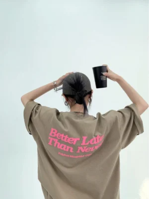 Light coffee oversized Better Late Than Never graphic tee with rose pink foam print on back