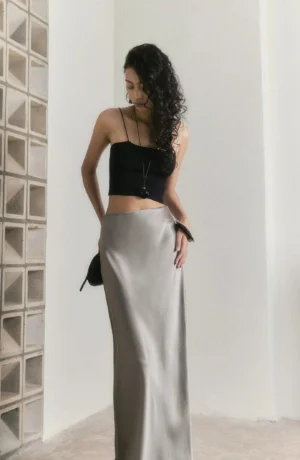 Agate grey satin high-waisted fishtail maxi skirt side view showing the fluid bias-cut drape and slim silhouette