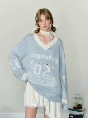 Baby blue birthday cake V-neck oversized knit sweater with contrast trim and jacquard graphic styled with white ruffled shorts