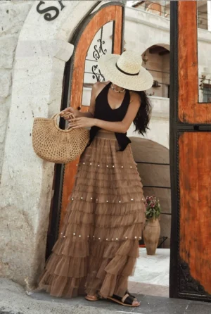 Black 3D rose halter knit top with a fitted sleeveless silhouette styled with a tiered tulle maxi skirt