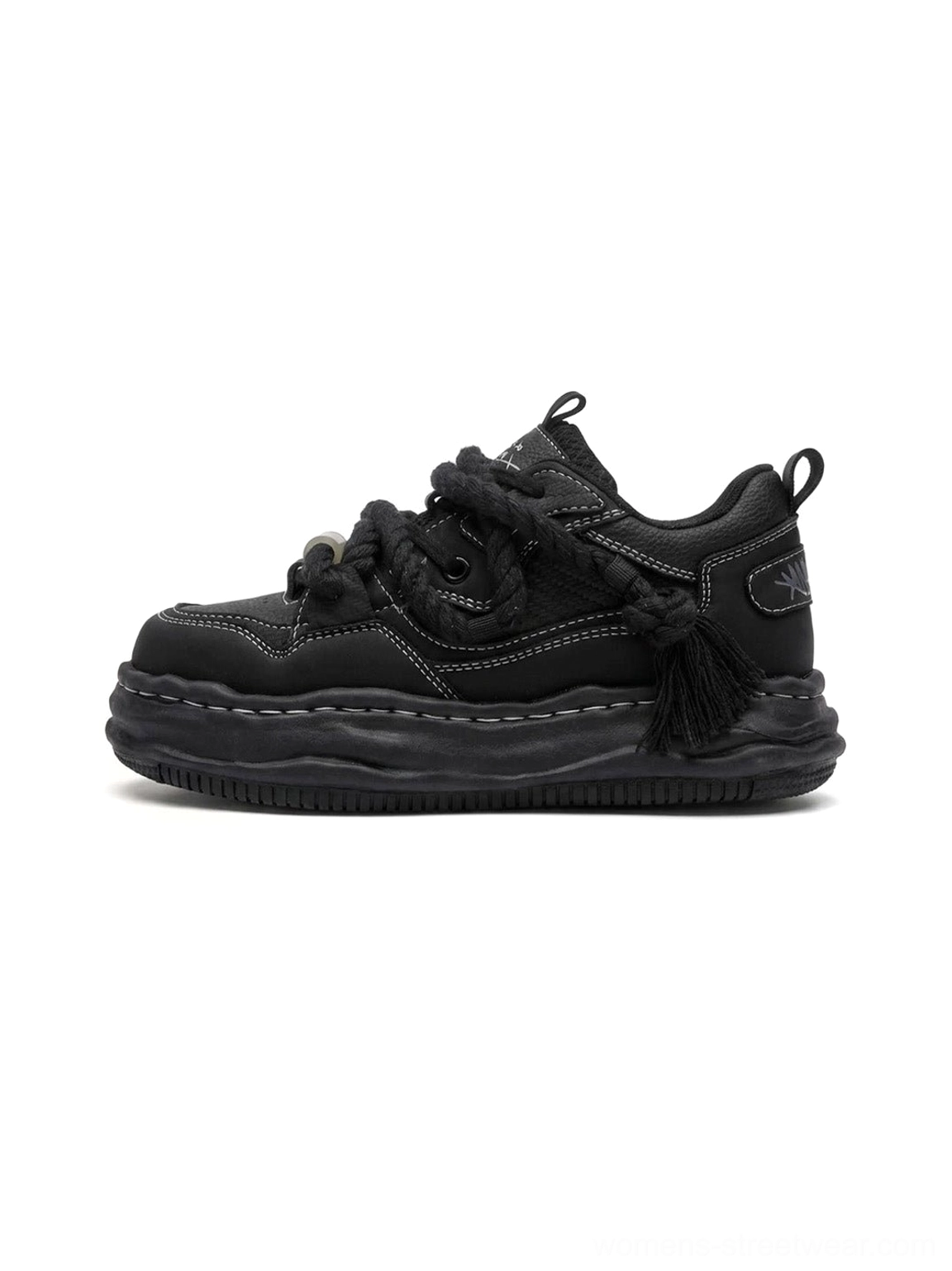 Black 7CM wavy platform sneaker shown in side profile with chunky sculpted outsole rope laces metal toggle and tassel heel detail