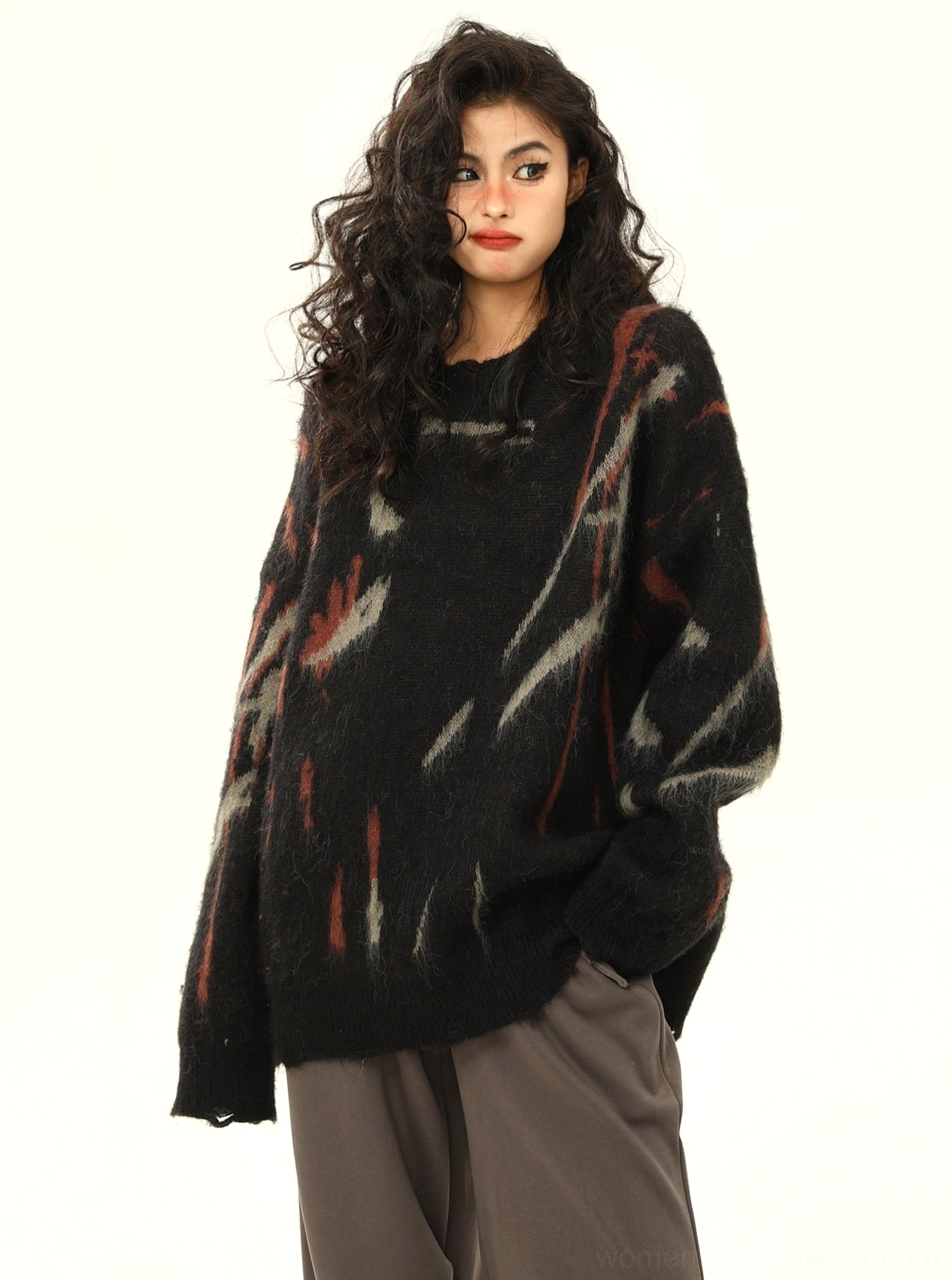 Side view of black abstract graffiti oversized streetwear sweater with loose draped silhouette