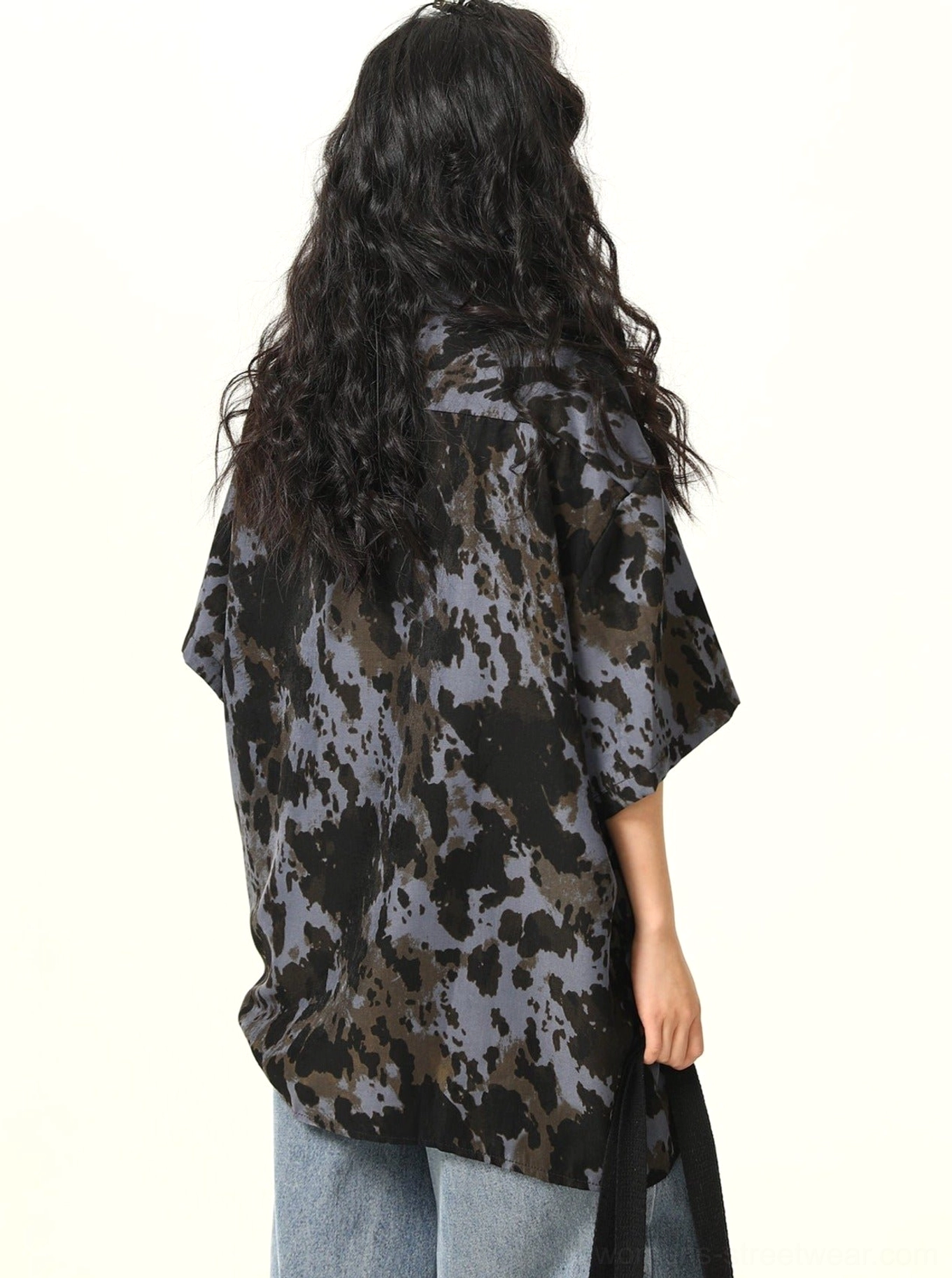 Full back view of black abstract splash print oversized button-up shirt with relaxed curved hem