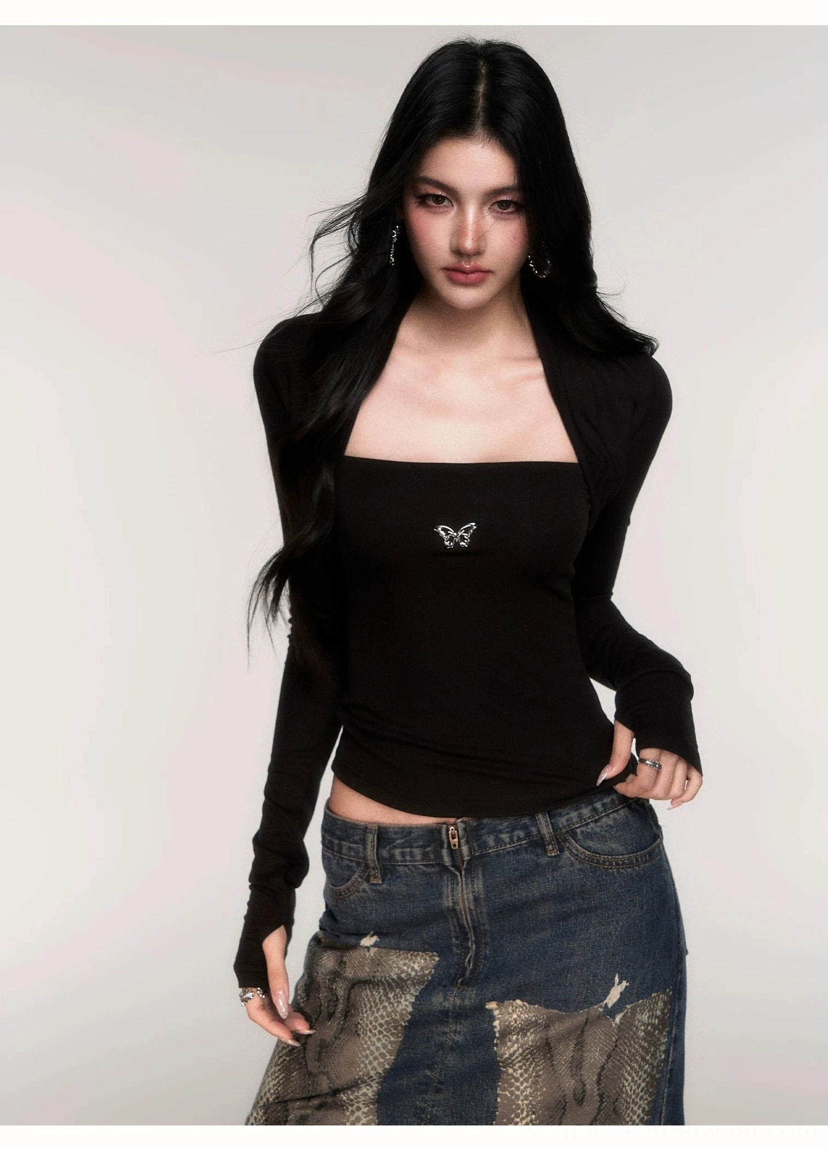 Black Acubi butterfly knit top with slim ribbed silhouette, attached shrug sleeves, square neckline, and blue wide-leg denim