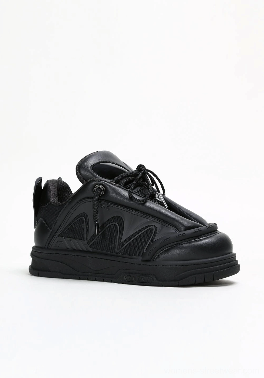 Black alien head platform sneakers side profile showing sculpted leather-look panels and elevated sole