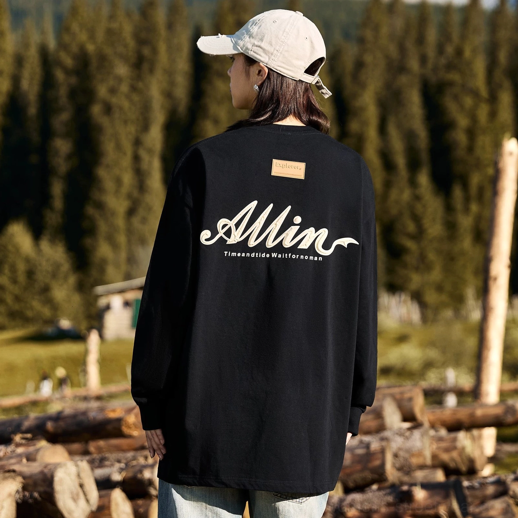 Black loose fit alpine script graphic cotton long sleeve tee with white back print for casual streetwear styling