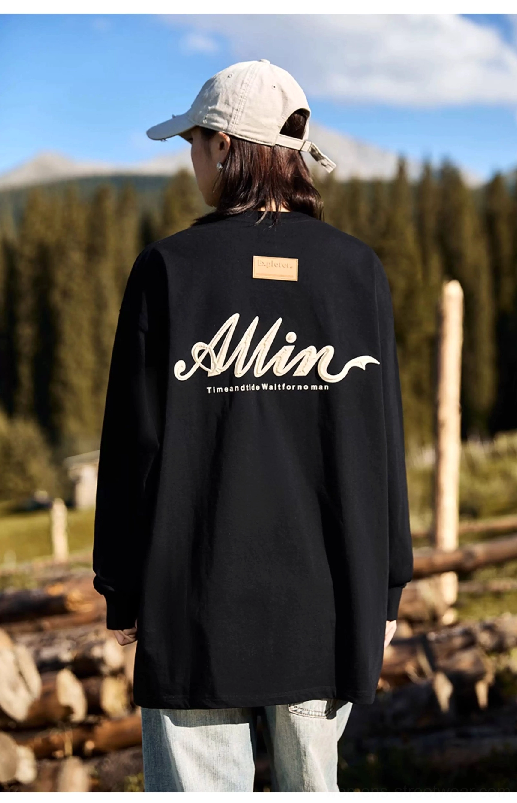 Black oversized cotton long sleeve streetwear tee with contrasting alpine script back graphic and upper back patch