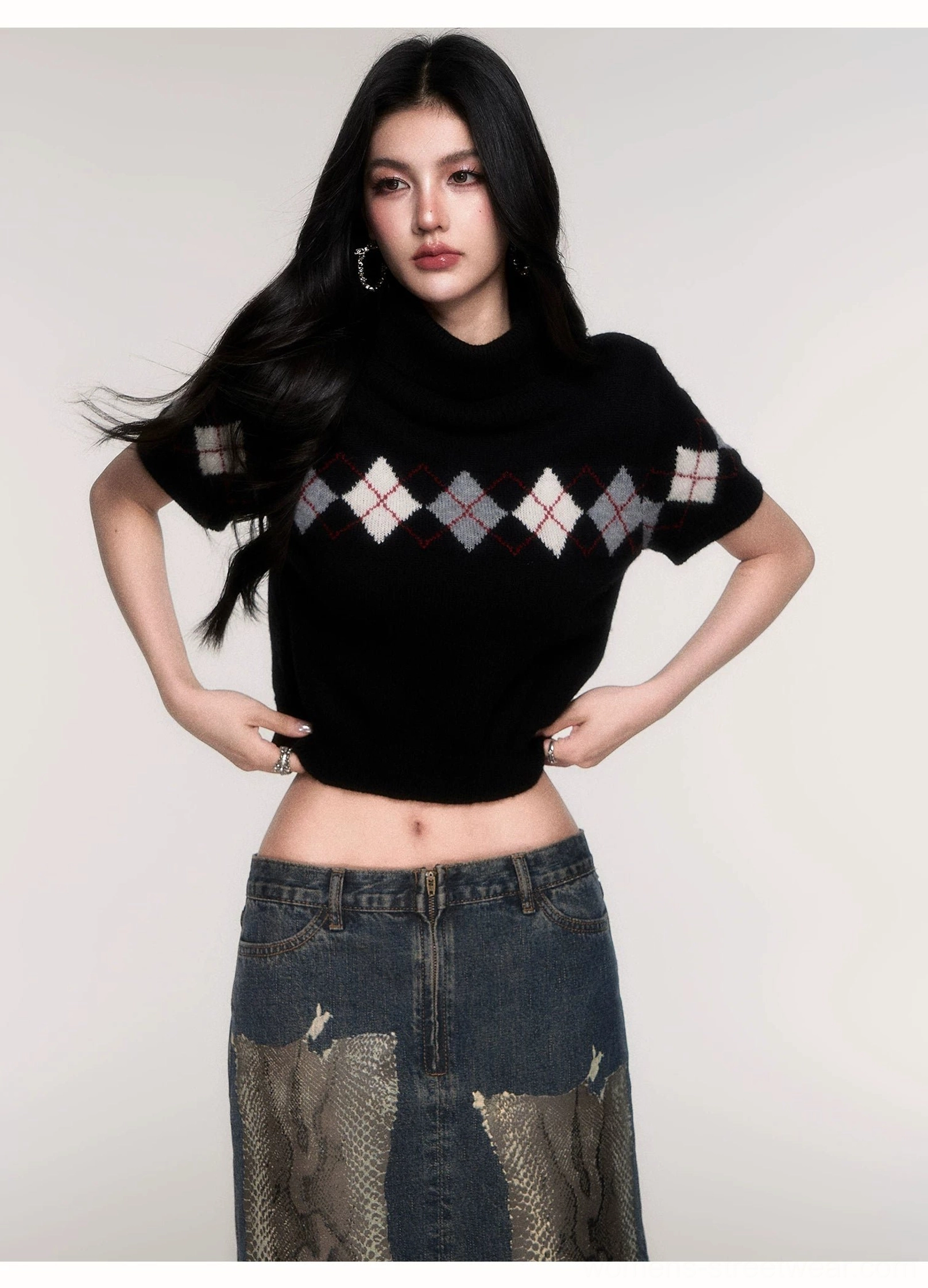 Full-body outfit featuring a black cropped argyle turtleneck sweater with short sleeves and contrast chest pattern paired with a patchwork denim midi skirt