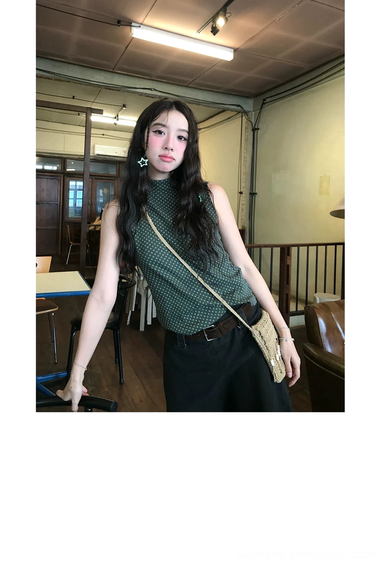 Black asymmetric A-line cotton midi skirt front view styled with a sleeveless top and woven shoulder bag