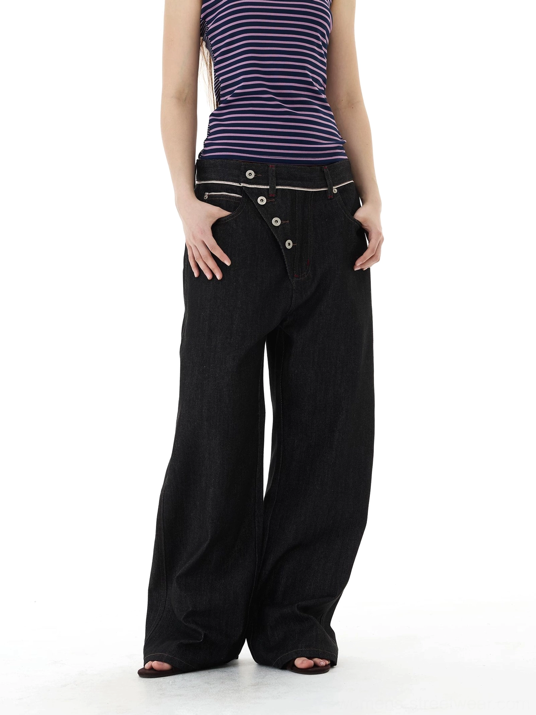Black asymmetric button placket wide-leg jeans with contrast waistband detail styled with a purple striped cropped top