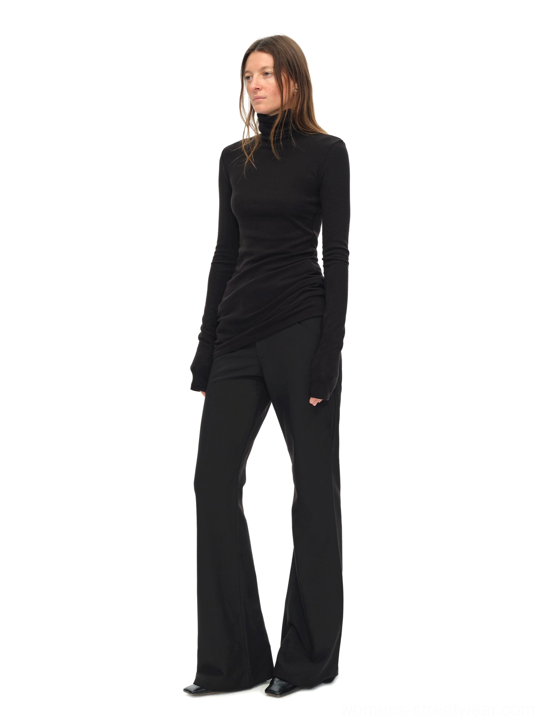 Side view of black slim silhouette turtleneck top with asymmetric hem and fitted long sleeves
