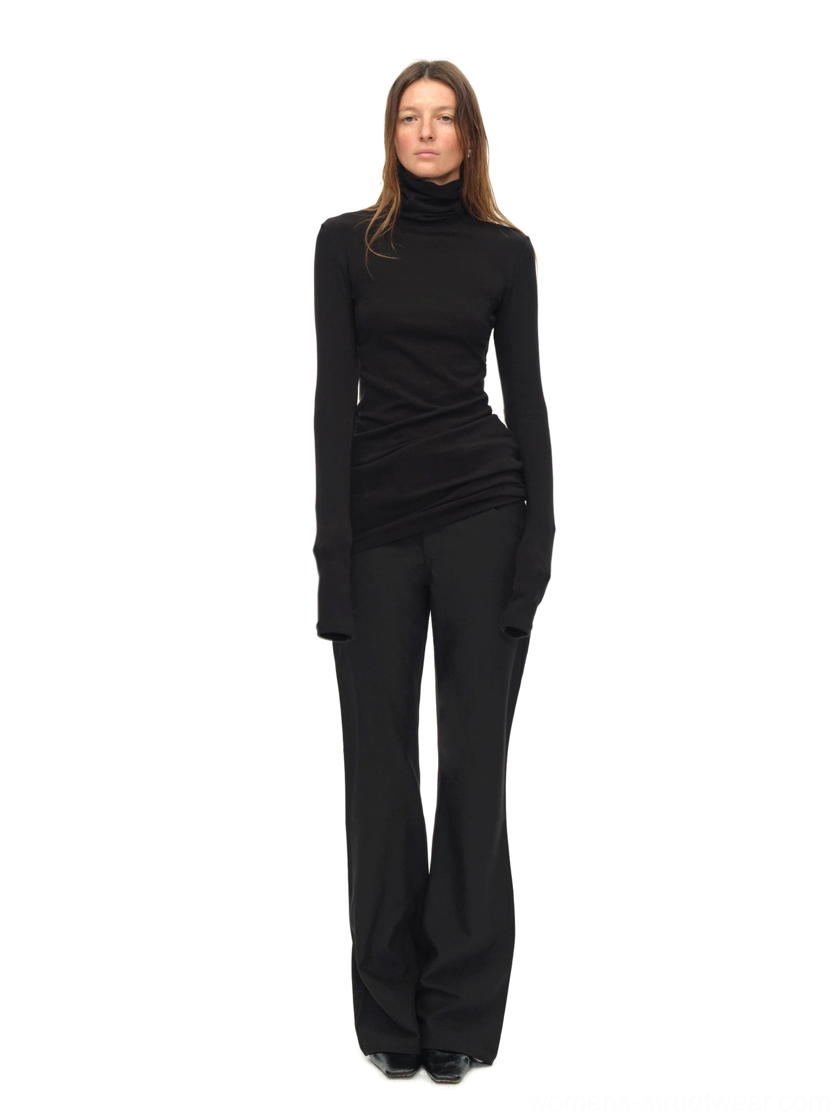 Black fitted high turtleneck knit top with stretchy fine knit texture and flared trousers
