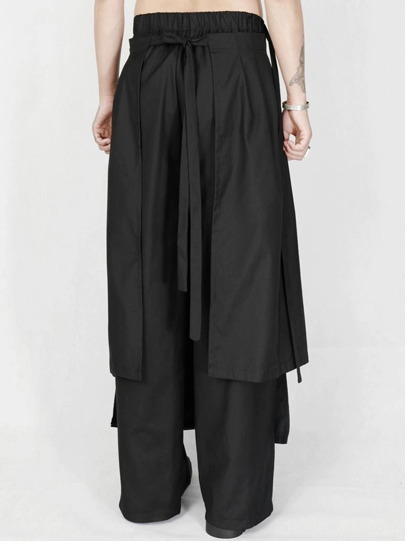Black asymmetric draped wide-leg trousers with layered avant-garde streetwear construction