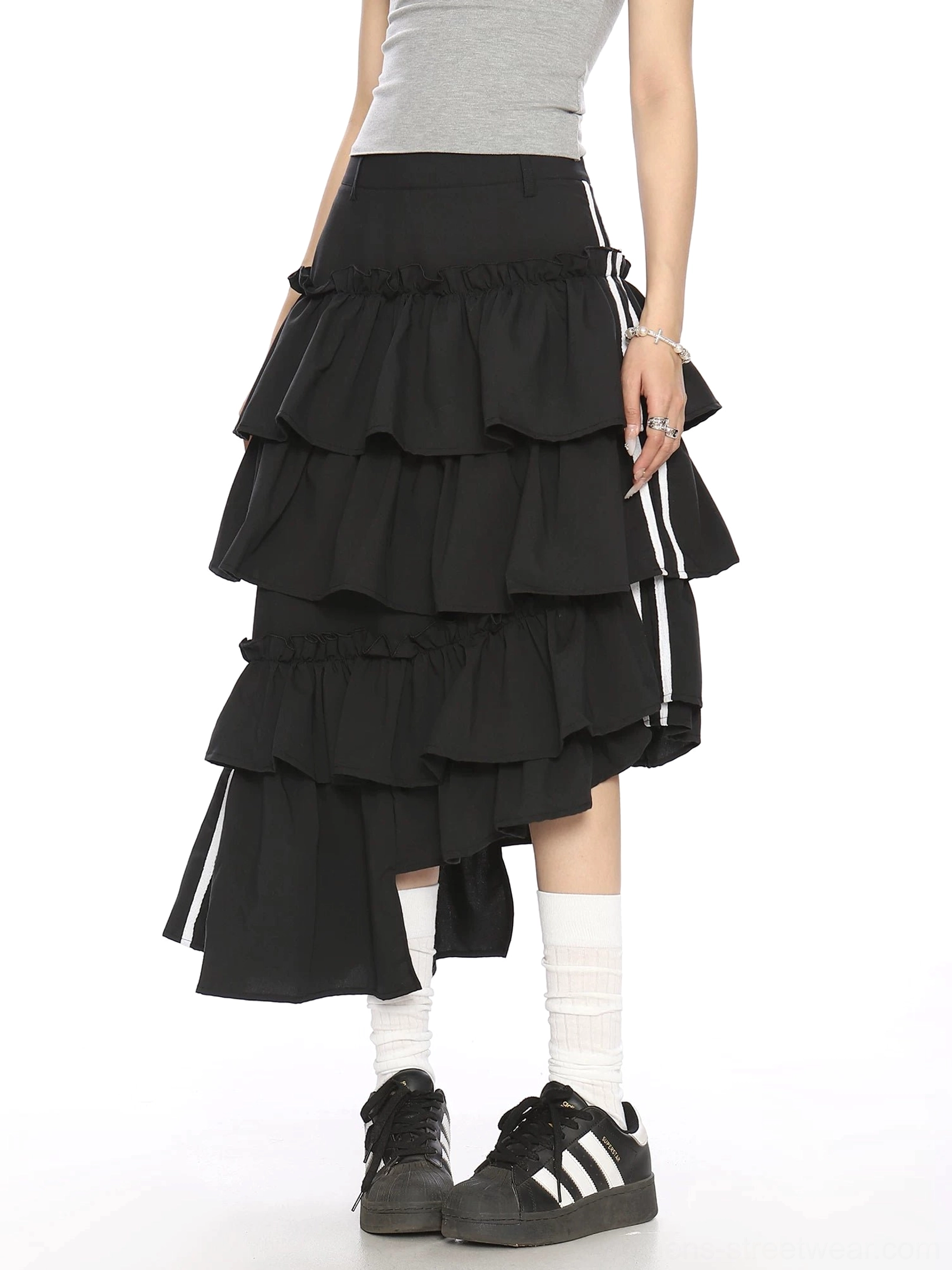 Back three quarter view of black asymmetric layered ruffle midi skirt with contrast white stripe ribbon side details
