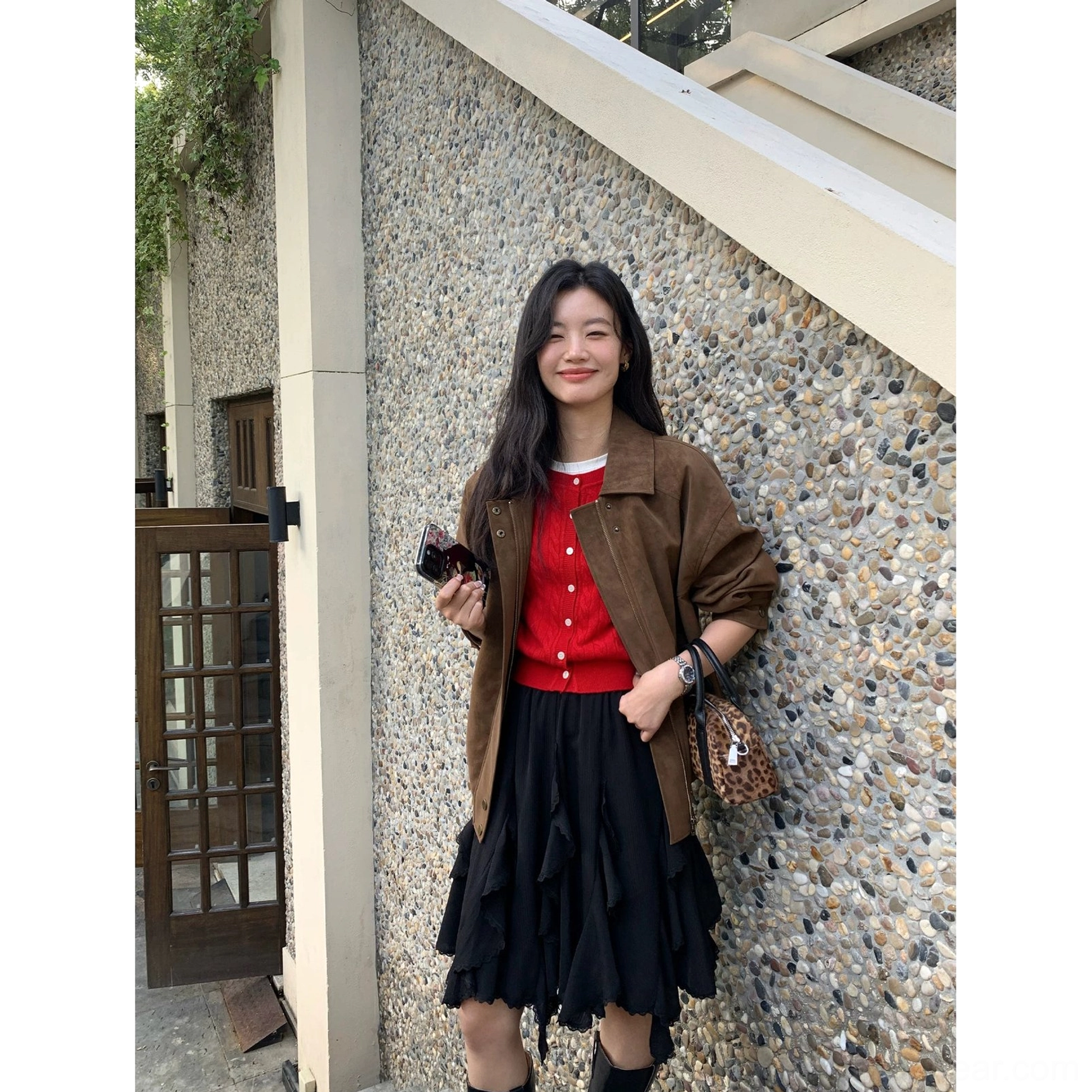 Black asymmetric layered ruffle mini skirt styled with a red top brown coat leopard print bag and boots