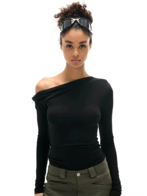 Black asymmetric off-shoulder ruched thumbhole long sleeve top shown in a front full-body streetwear outfit