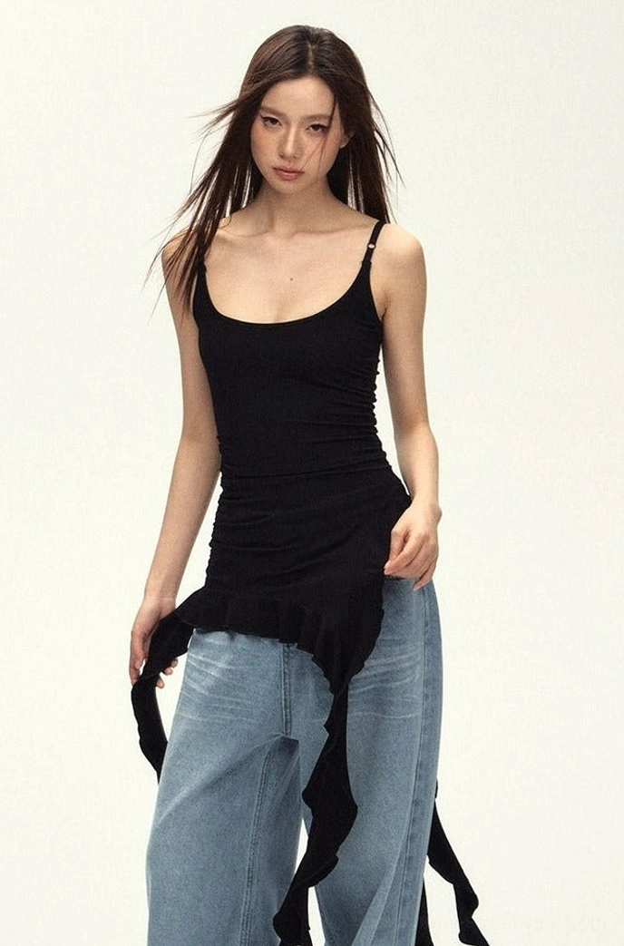 Black asymmetric ruched cami top with adjustable straps and gathered waist styled with relaxed light-wash jeans