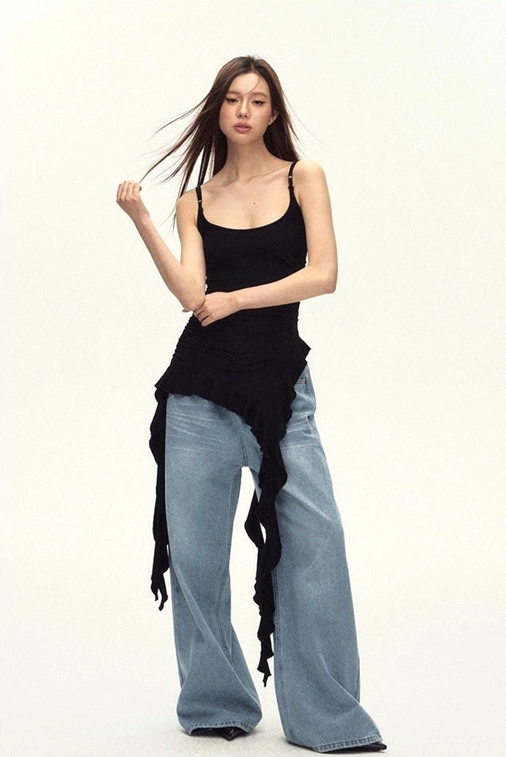 Black asymmetric streetwear cami top with feminine ruching and flowing layered hem for city styling