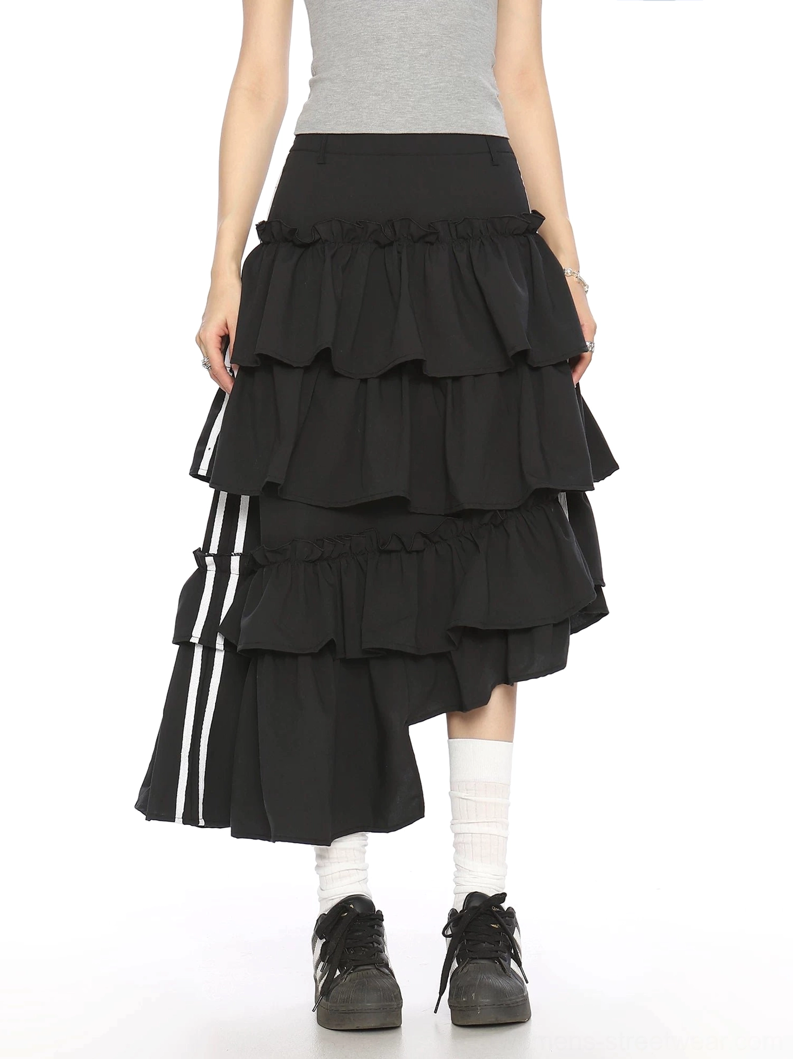 Direct back view of black asymmetric tiered ruffle midi skirt with white stripe ribbon detail and high-low hem