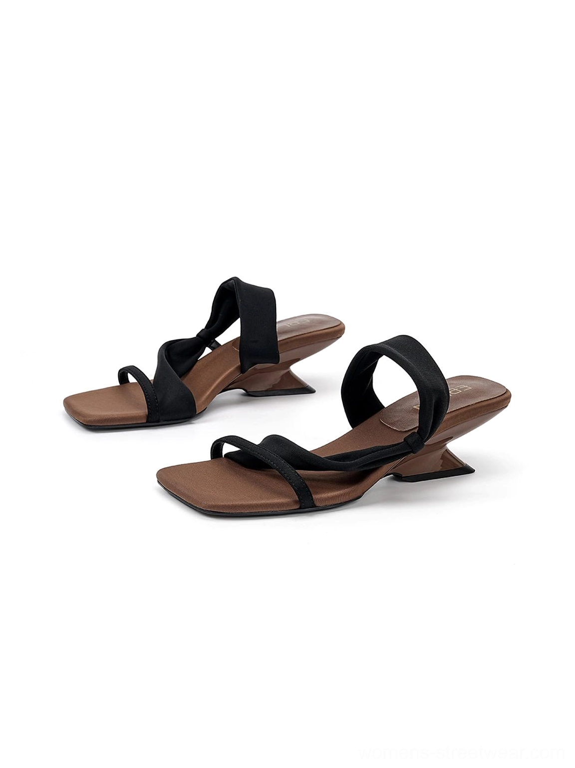 Black asymmetric wedge slide sandals with sculptural low heels and square open toes three quarter view