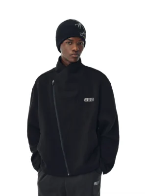 Black asymmetric zip high-neck streetwear jacket on a male model wearing a knit beanie with relaxed dropped shoulders