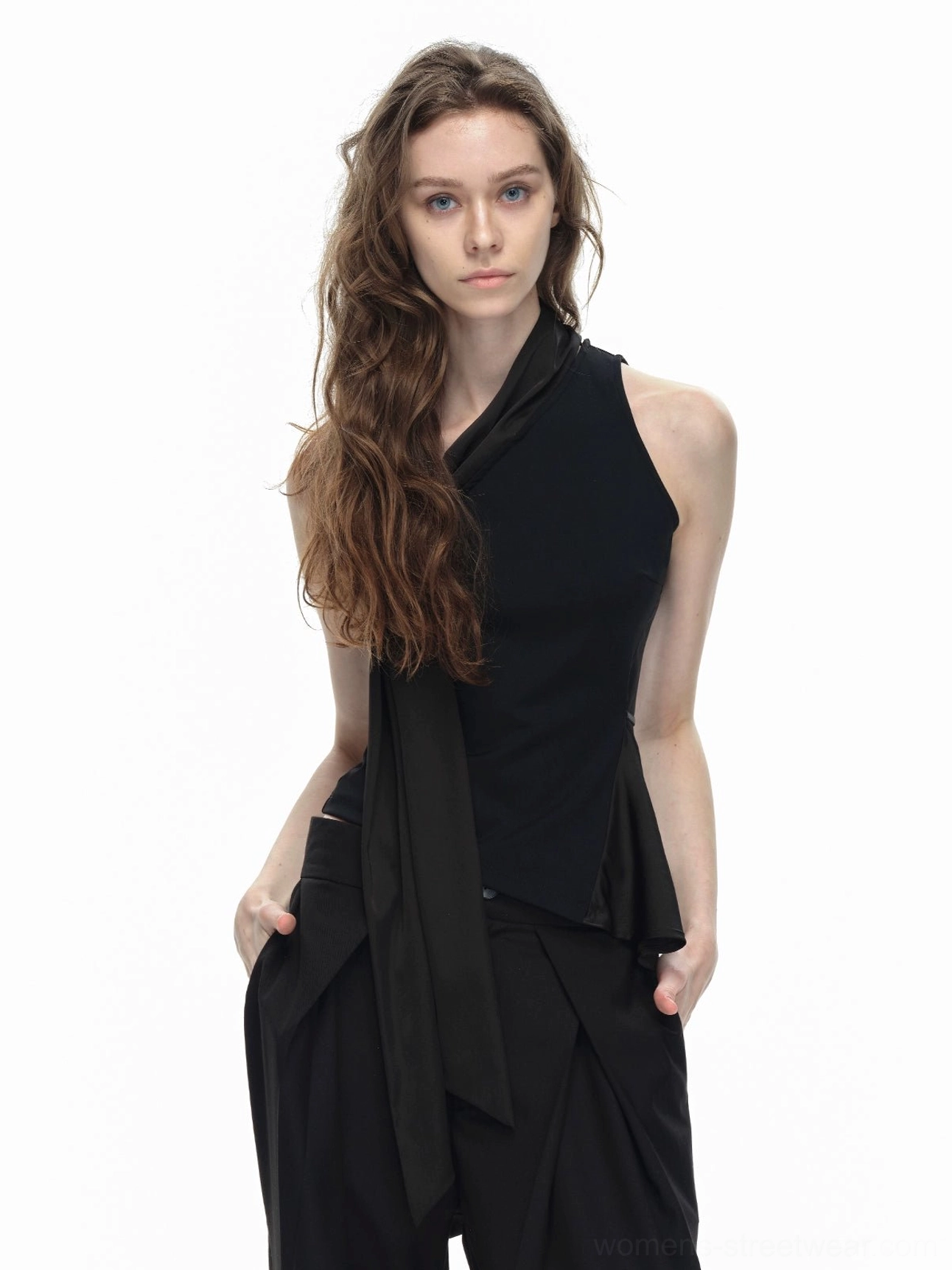 Black asymmetrical halter top rear side view with long trailing waist tie sash and fitted sleeveless silhouette