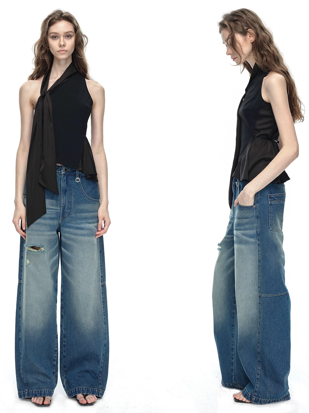 Black asymmetrical halter neck top with long side sash paired with distressed blue wide-leg jeans studio front view