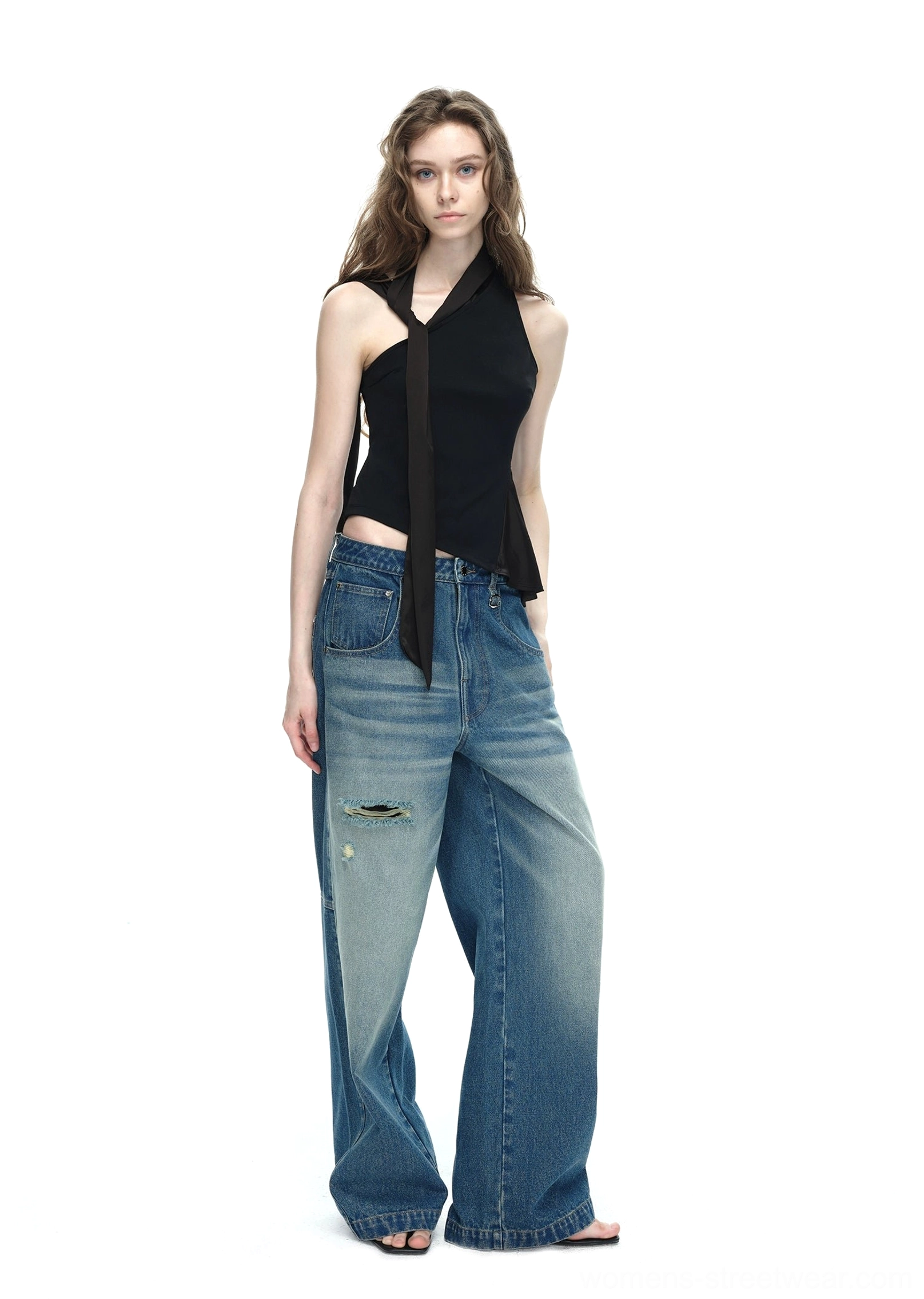 Black asymmetrical halter top front view with adjustable waist tie sash styled as a Y2K streetwear denim outfit