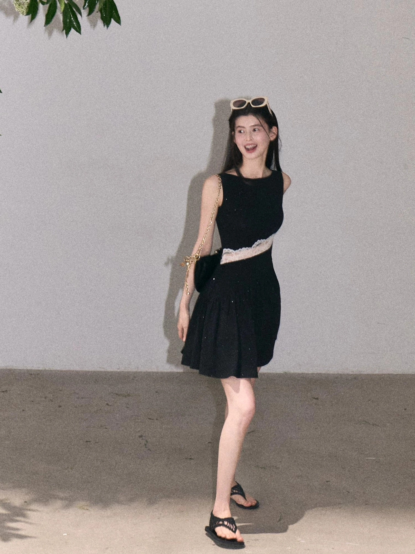 Black asymmetrical lace waist mini dress with white diagonal lace panel flared skirt and crossbody bag