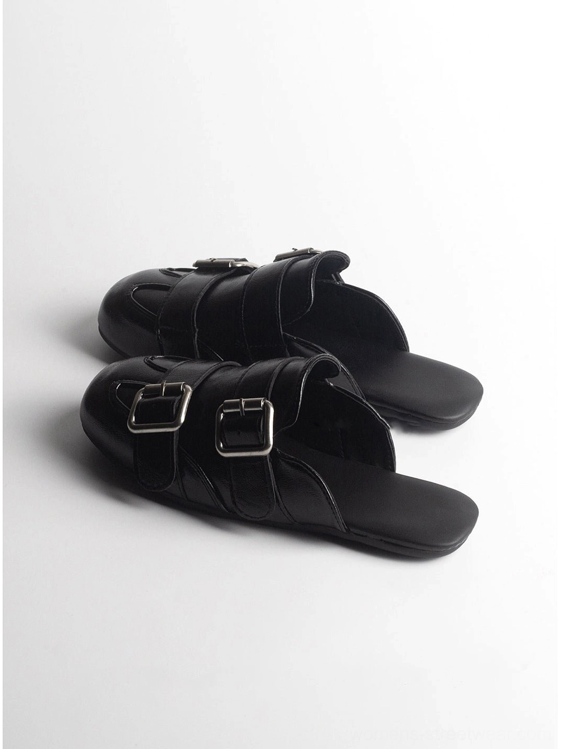 Pair of black backless double-buckle leather mule loafers with polished upper and square toe