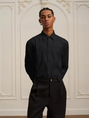 Black baroque embroidered long-sleeve streetwear shirt styled with tailored black trousers for a relaxed formal outfit