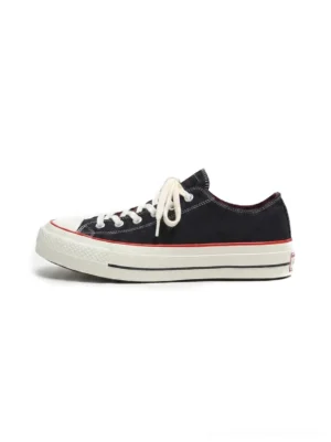 Black bat print platform canvas sneakers shown in side profile with off-white rubber toe cap, red trim, white laces, and hidden lift streetwear sole