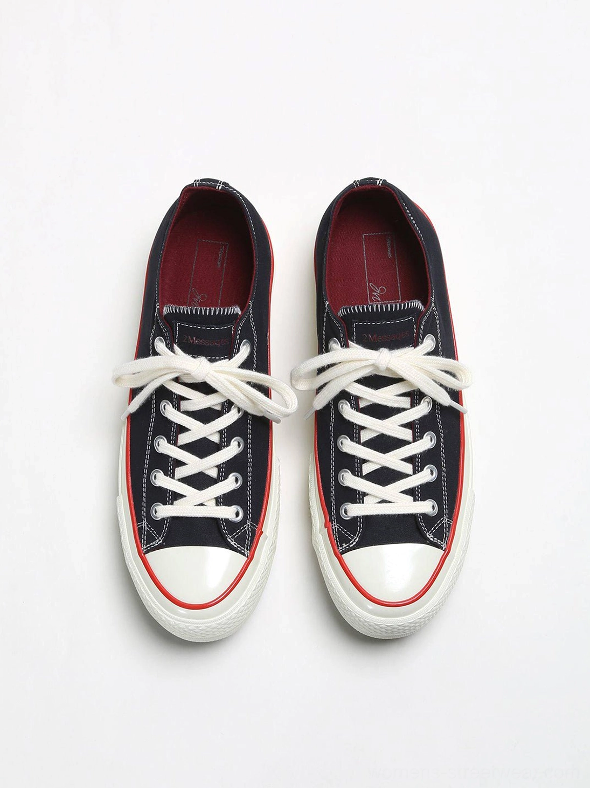 Top-down view of black bat print platform canvas sneakers with white flat laces, burgundy inner lining, and cushioned insoles