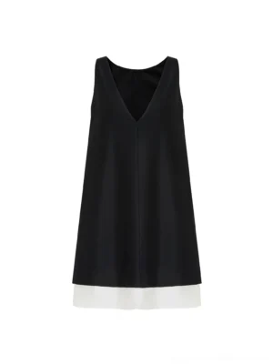Black and beige color-block V-back shift dress shown in a full front flat lay with a relaxed A-line silhouette and contrasting ivory layered hem