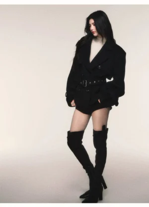 Side view of black belted wool blend peacoat with oversized tailored silhouette and double-breasted buttons