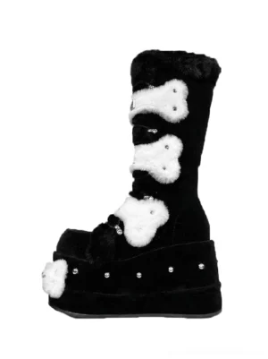 Black bone applique faux fur platform boots shown from the side with white plush bone decorations studded soles and fuzzy trim