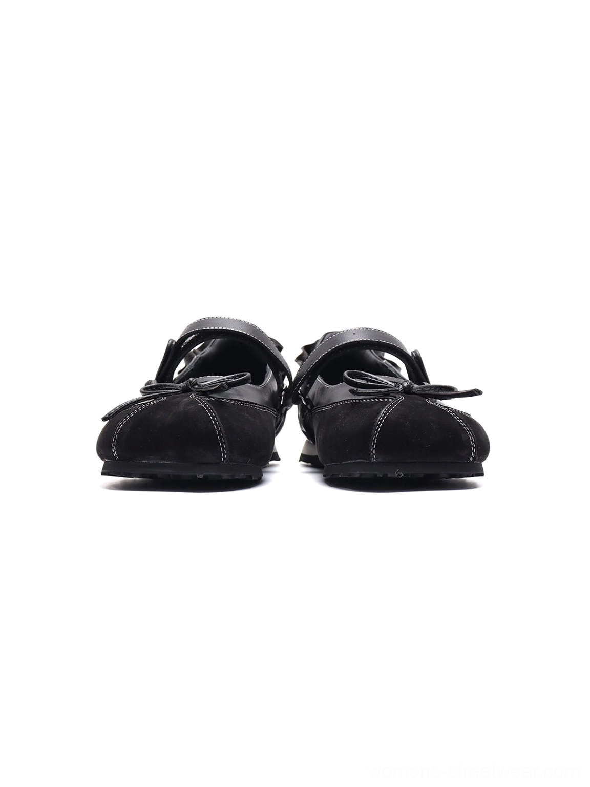 Front three-quarter view of black bow ballet flats featuring split-square toes, Mary Jane straps and gathered heel details