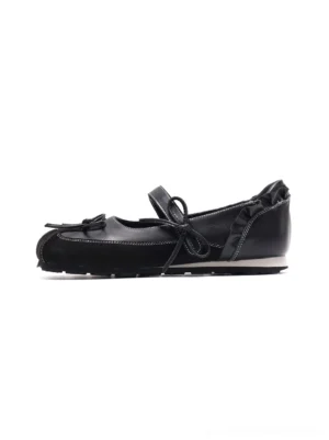 Black bow Mary Jane ballet flats side profile with leather-look upper, contrast stitching, ruffled heel trim and segmented white rubber sole